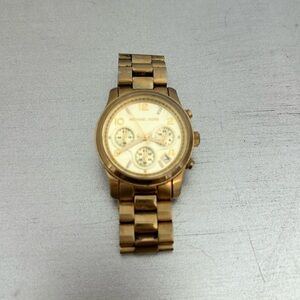Michael Kors gold watch. Slightly tarnished, good condition. Needs new battery.